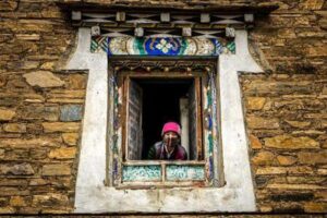 Woman looking through a window